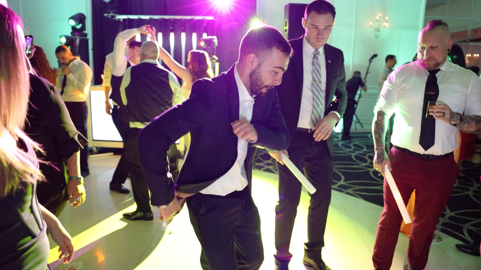 Guests dancing on the floor at The Gramercy at Lakeside Manor under coloured lighting, with the LED DJ booth behind them