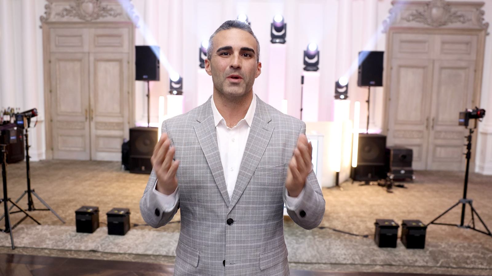 Joey Disaronno on the microphone in the ballroom at Park Chateau Estate and Gardens, with the DJ system and moving-head lighting rigged behind him