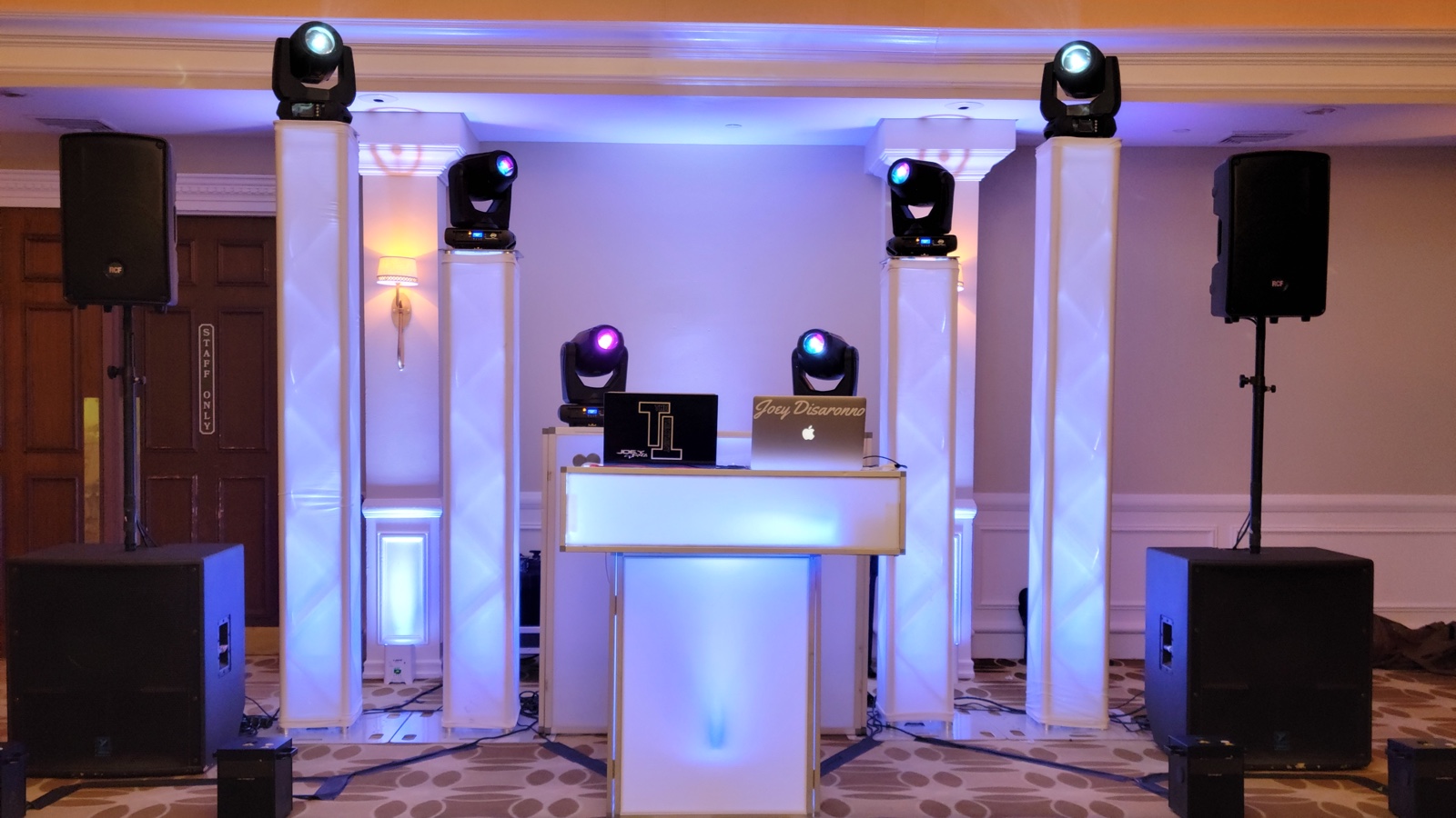 The Disaronno Events booth and LED columns with moving-head lighting set up in the panelled ballroom at Richmond County Country Club, Todt Hill