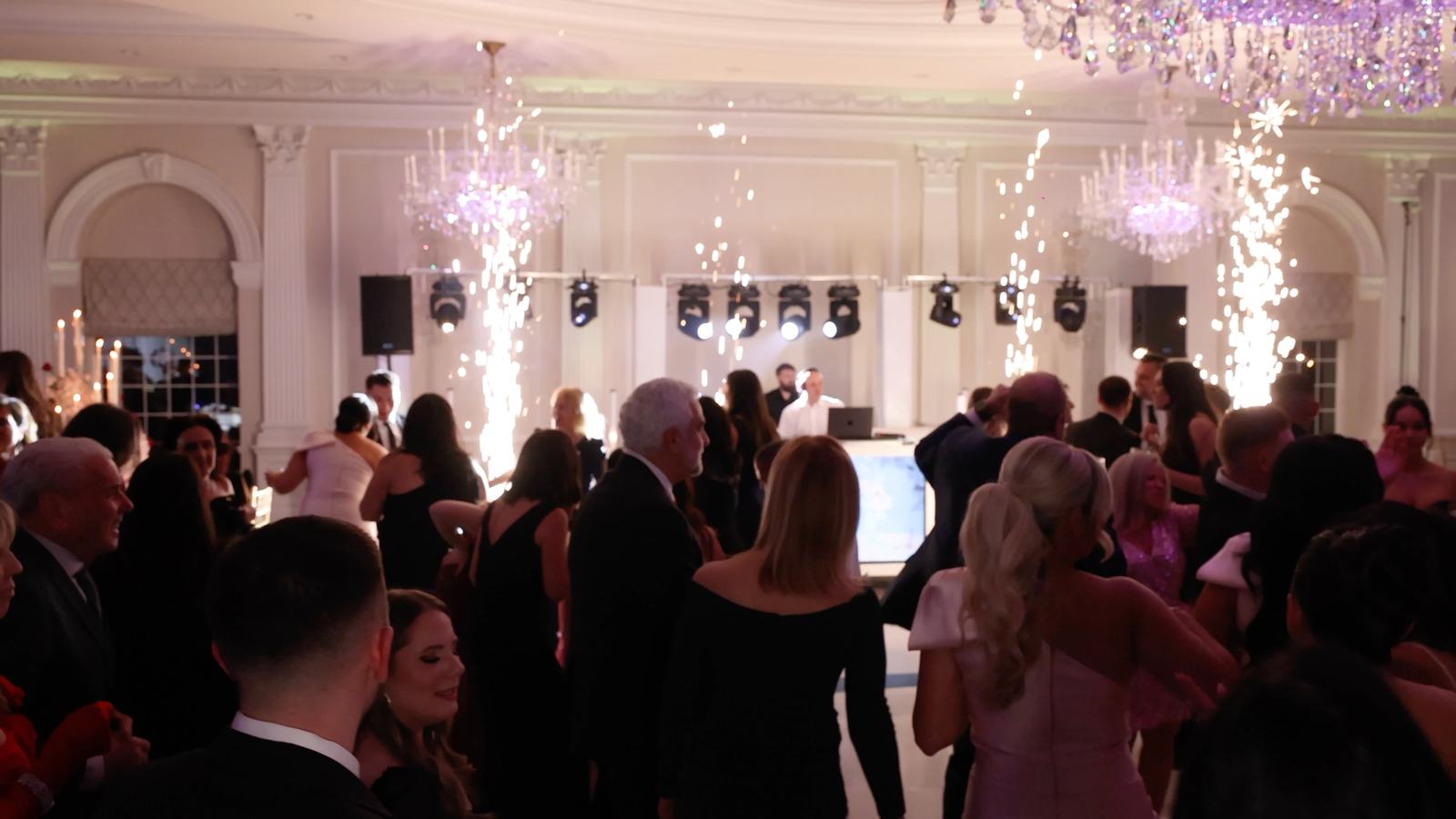 Cold spark fountains firing across the chandeliered ballroom at The Rockleigh as guests fill the dance floor